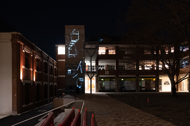 A projection onto the lift shaft in the courtyard at Collingwood Yards